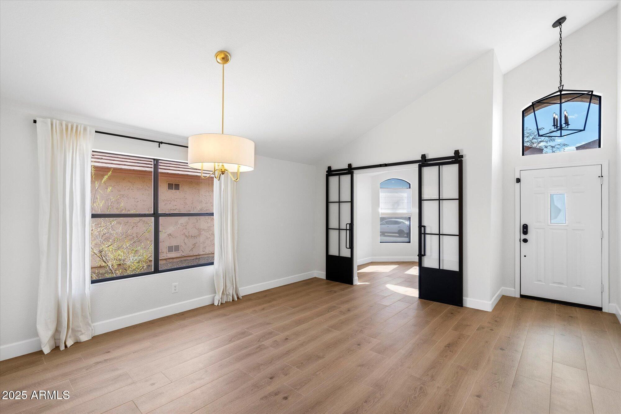 4706 East Jaeger Road Phoenix, AZ 85050 - Photo 6 of 30 a view of an empty room with window and wooden floor