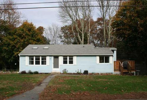 4 Hill Street Ledyard, CT 06339 - Photo 1 of 1 a front view of a house with a garden and trees