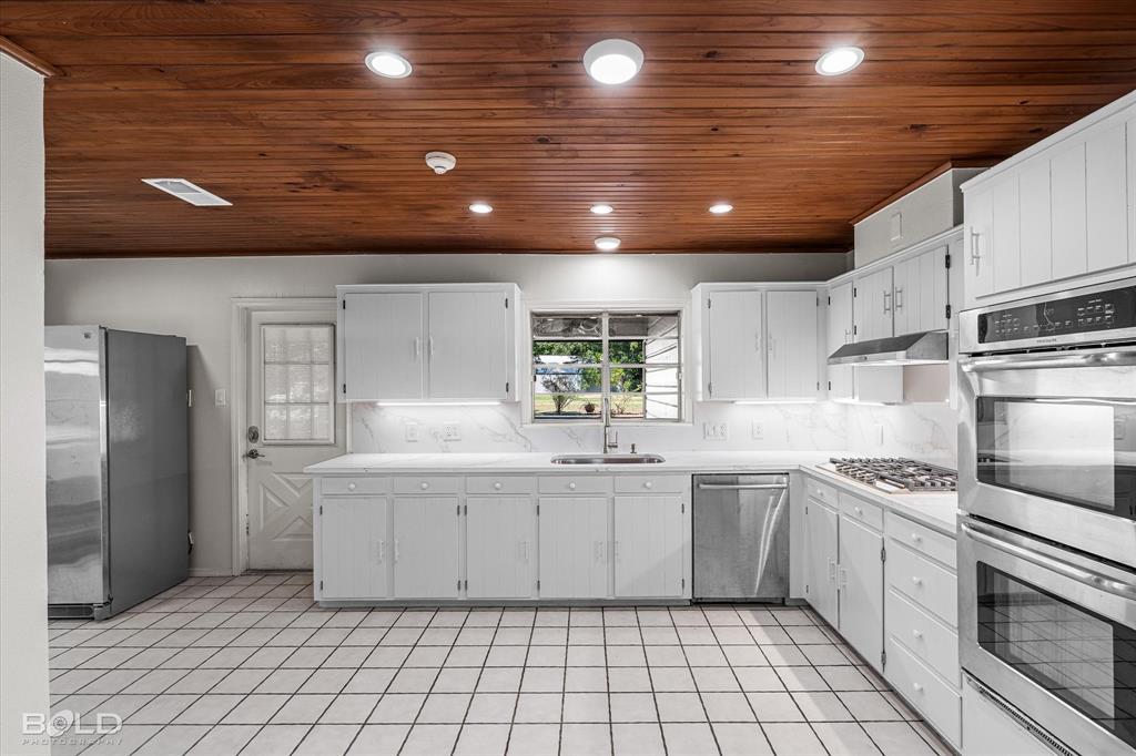 5800 Jefferson Paige Road Shreveport, LA 71119 - Photo 16 of 39 a kitchen with a sink stainless steel appliances and cabinets