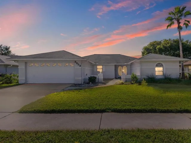 a front view of a house with a garden and yard