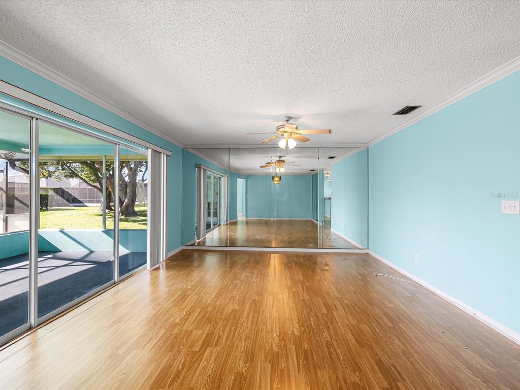 5853 Redhawk Drive New Port Richey, FL 34655 - Photo 18 of 38 wooden floor in an empty room with a window