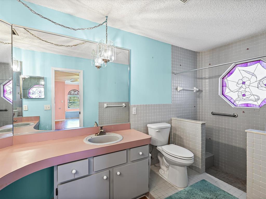 5853 Redhawk Drive New Port Richey, FL 34655 - Photo 27 of 38 a bathroom with a toilet a sink and mirror