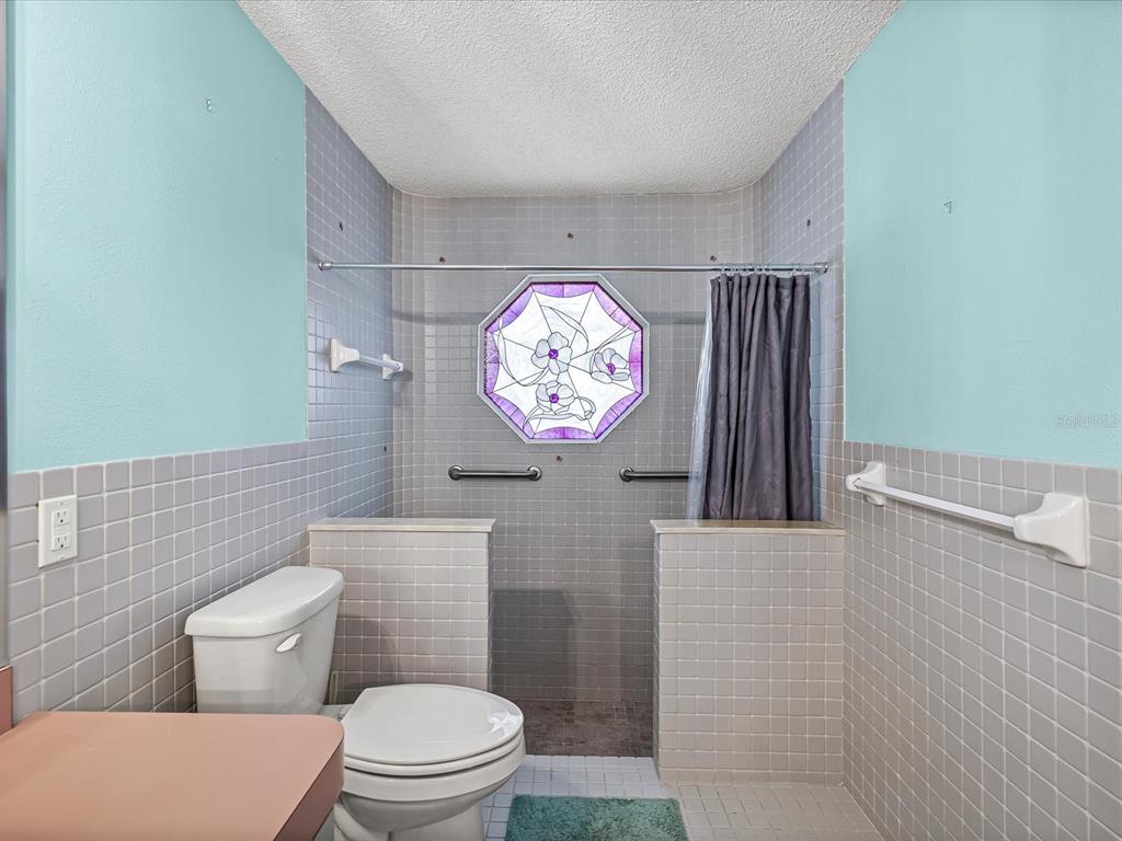 5853 Redhawk Drive New Port Richey, FL 34655 - Photo 29 of 38 a bathroom with a toilet a sink and mirror