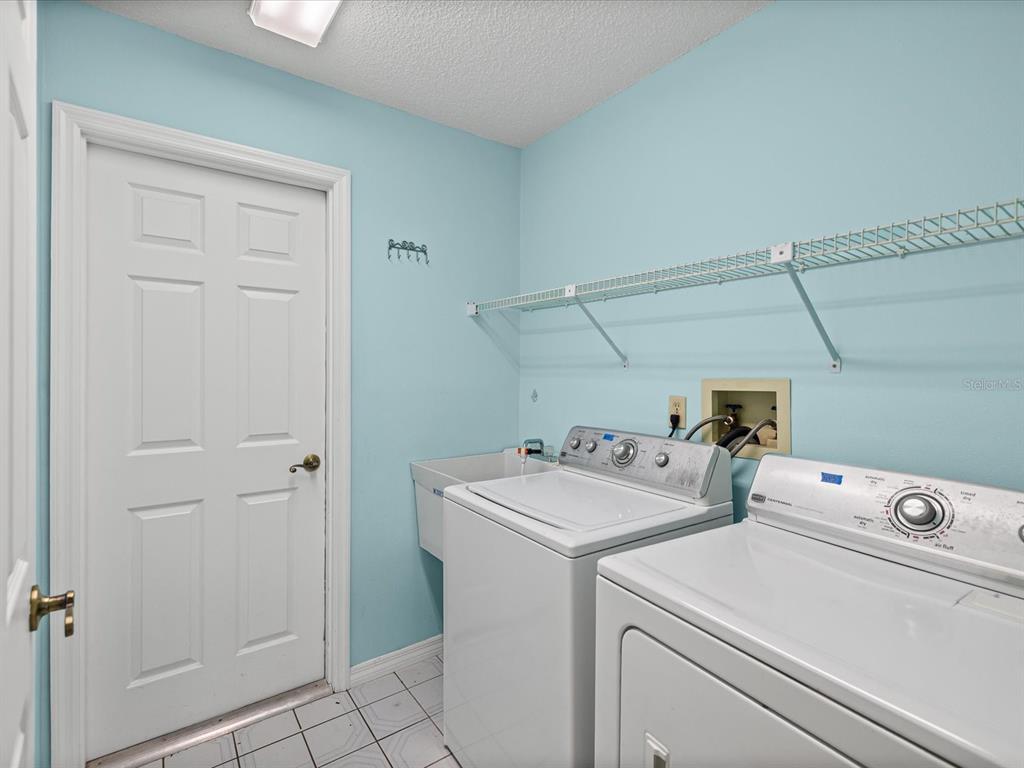 5853 Redhawk Drive New Port Richey, FL 34655 - Photo 32 of 38 a utility room with dryer and washer