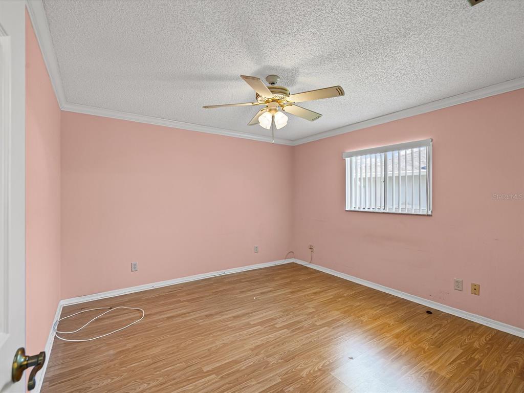 5853 Redhawk Drive New Port Richey, FL 34655 - Photo 35 of 38 a view of a big room with carpet and a chandelier fan