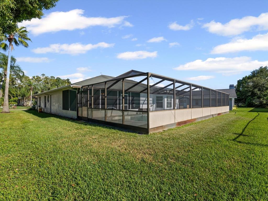 5853 Redhawk Drive New Port Richey, FL 34655 - Photo 37 of 38 a view of a house with backyard and porch