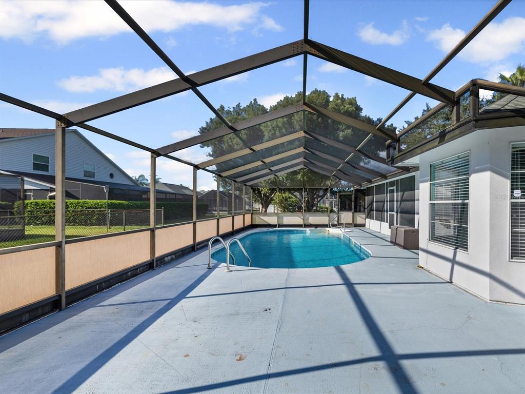 5853 Redhawk Drive New Port Richey, FL 34655 - Photo 5 of 38 a view of swimming pool with yard in front of it