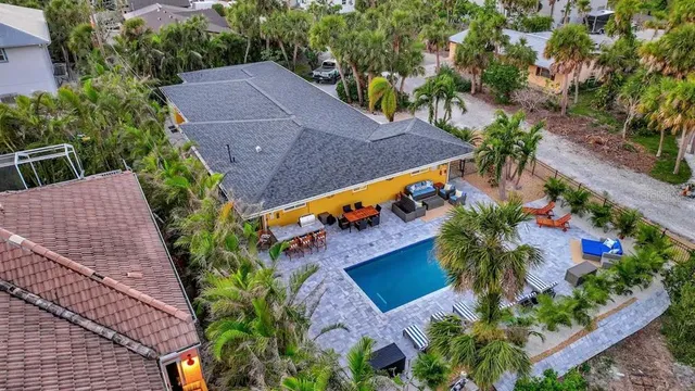 an aerial view of house with yard and seating area