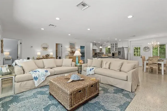 a living room with furniture and view of kitchen