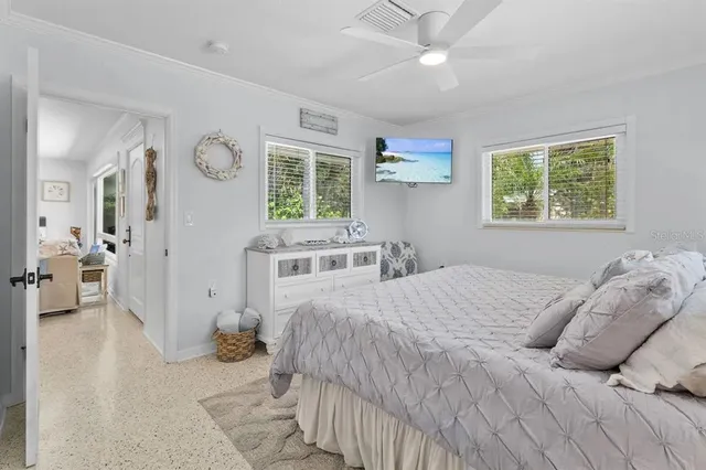 a bedroom with a large bed and a chandelier