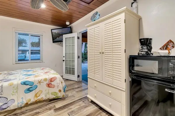 a bedroom with a bed and a tv on the dresser
