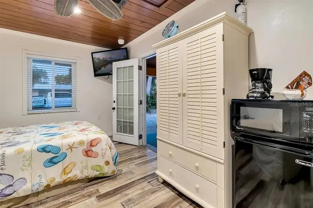 a bedroom with a bed and a tv on the dresser