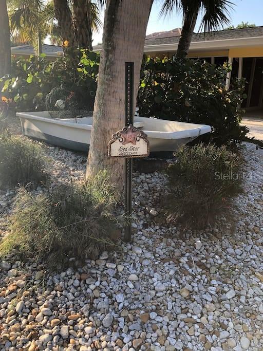 2795 North Beach Road, Unit A Englewood, FL 34223 - Photo 46 of 53 a view of a fountain in the yard with wooden fence