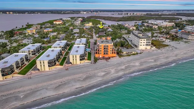 an aerial view of lake and residential houses with outdoor space