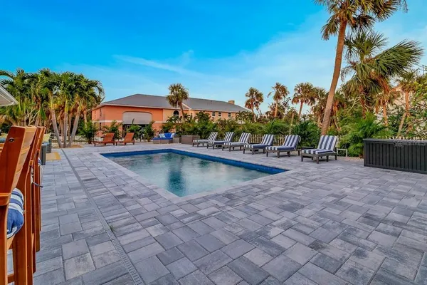 swimming pool view with a seating space