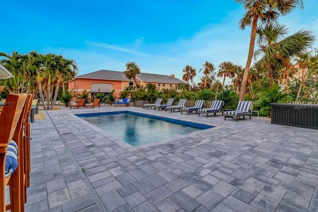 swimming pool view with a seating space