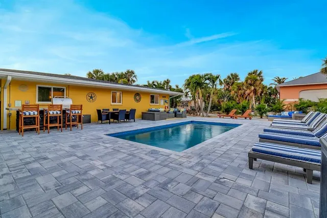 a view of a swimming pool with chairs