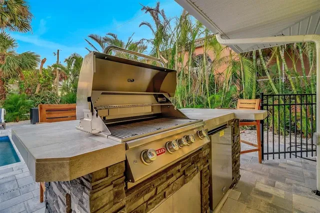 a view of a patio with table and chairs with wooden fence