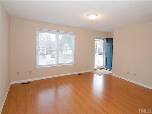 3629 Castlegate Drive Raleigh, NC 27616 - Photo 2 of 9 an empty room with wooden floor and windows