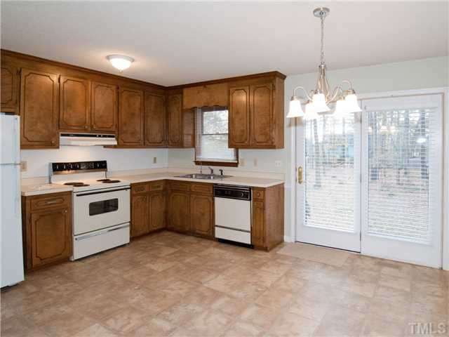 3629 Castlegate Drive Raleigh, NC 27616 - Photo 3 of 9 a kitchen with stainless steel appliances granite countertop a stove a sink and a refrigerator with cabinets