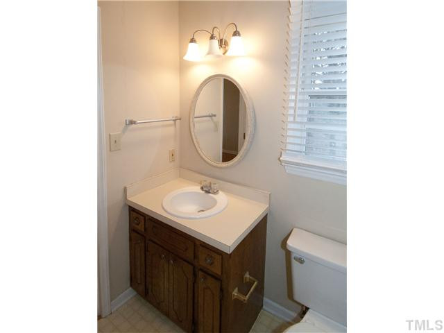 3629 Castlegate Drive Raleigh, NC 27616 - Photo 8 of 9 a bathroom with a sink and a mirror