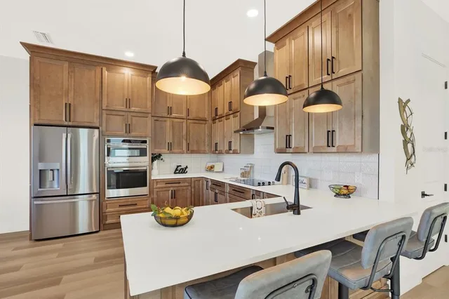 a kitchen with cabinets a sink and appliances