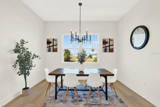 a view of a dining room with furniture and chandelier