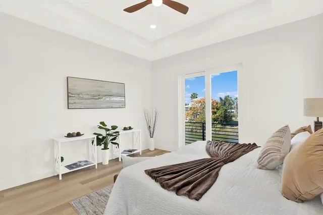 a bedroom with furniture and a large window