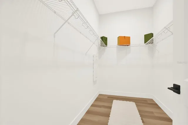 a view of a room with wooden floor