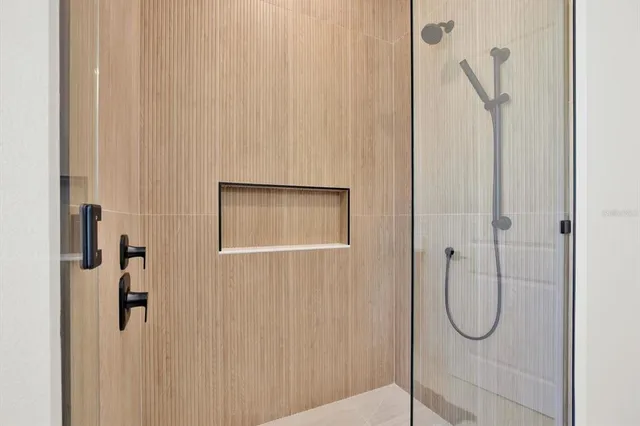 a bathroom with a glass shower door