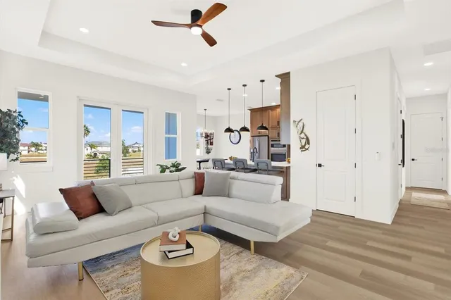a living room with furniture and a chandelier
