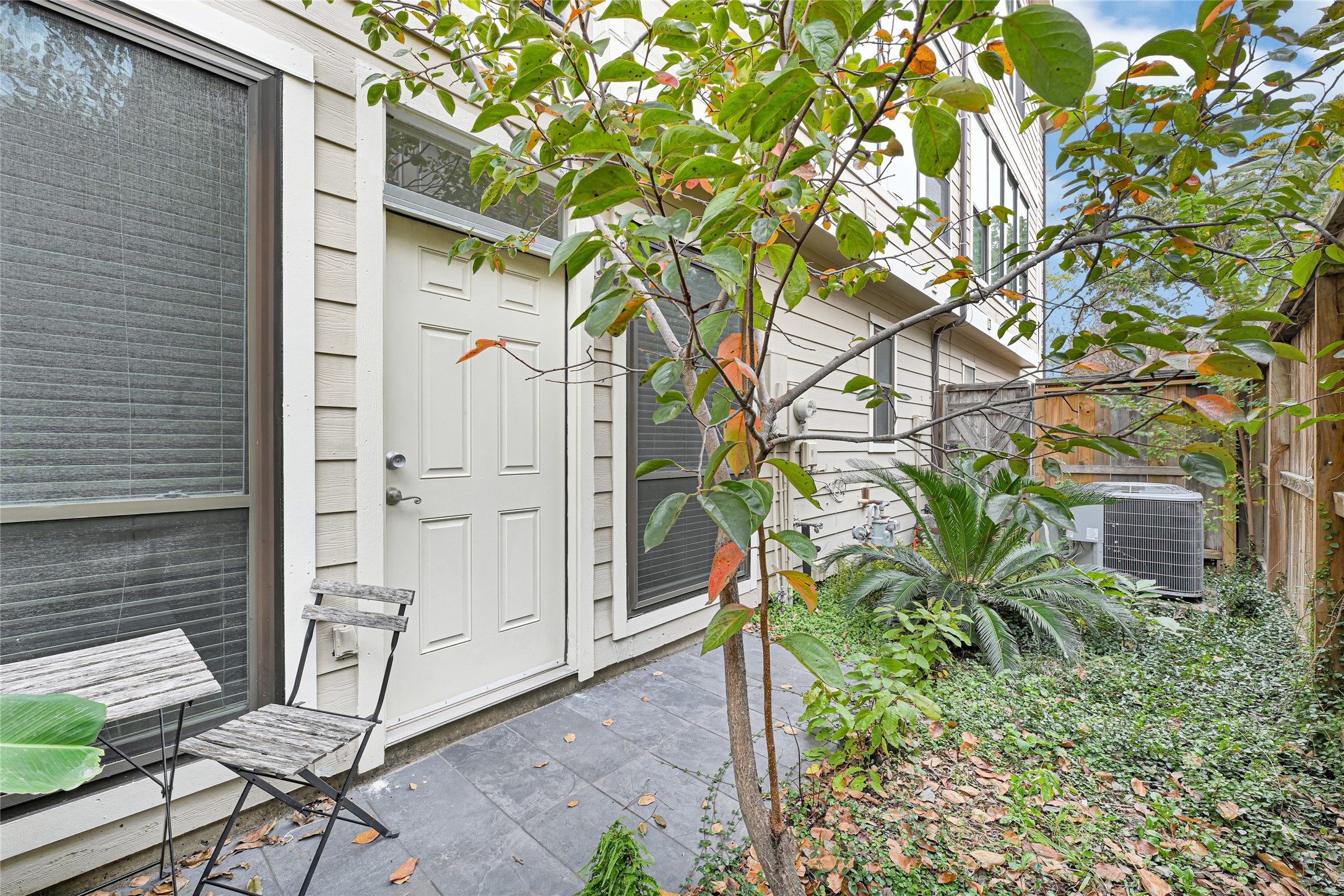 2414 Calumet Street, Unit B Houston, TX 77004 - Photo 25 of 27 a backyard of a house with table and chairs and wooden fence