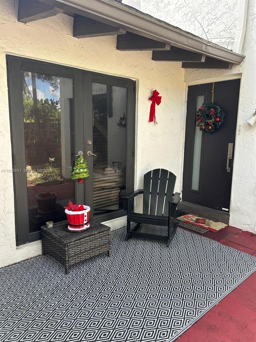 7100 Southwest 112th Place Miami, FL 33173 - Photo 1 of 21 a living room with furniture and a potted plant