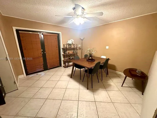 a view of a workspace with furniture and chandelier