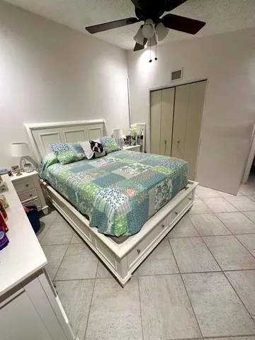 a bed sitting in a room next to a window