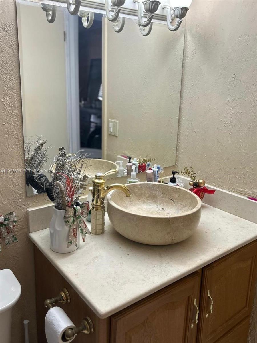 7100 Southwest 112th Place Miami, FL 33173 - Photo 14 of 21 a bathroom with a sink and a mirror