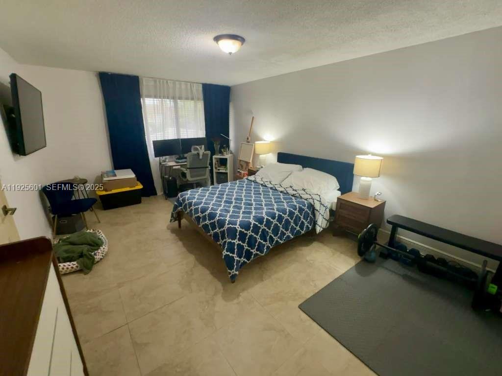 7100 Southwest 112th Place Miami, FL 33173 - Photo 17 of 21 a bedroom with bed and window