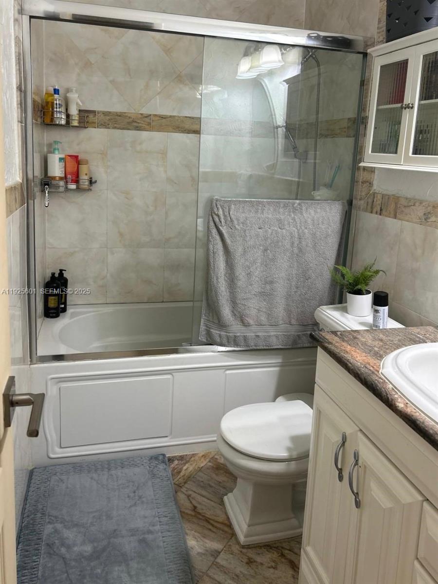 7100 Southwest 112th Place Miami, FL 33173 - Photo 19 of 21 a bathroom with a toilet and a shower