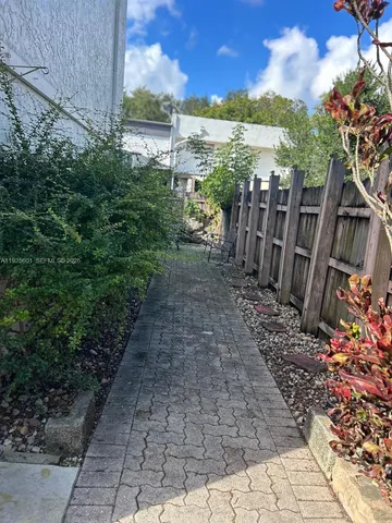 a view of a pathway with a yard of the house
