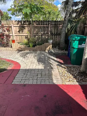 a view of a yard with plants and trees
