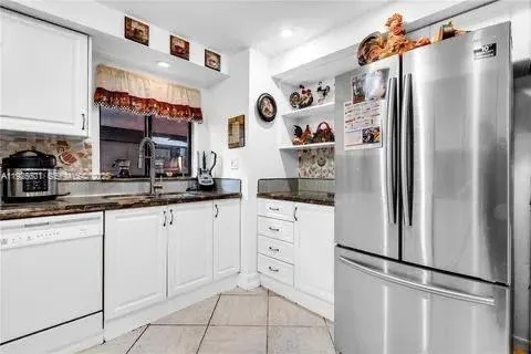 a kitchen with appliances and cabinets