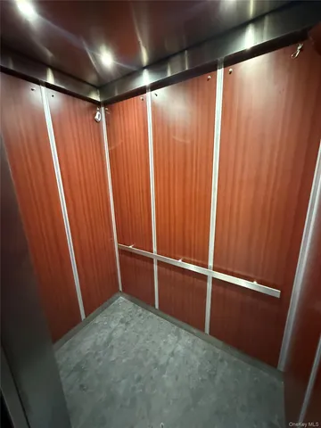 a view of empty room with wooden walls