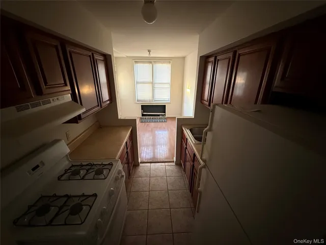 a kitchen with granite countertop stainless steel appliances a stove top oven a sink and dishwasher