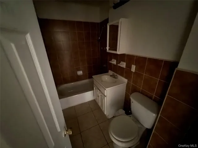 a white toilet sitting next to a sink