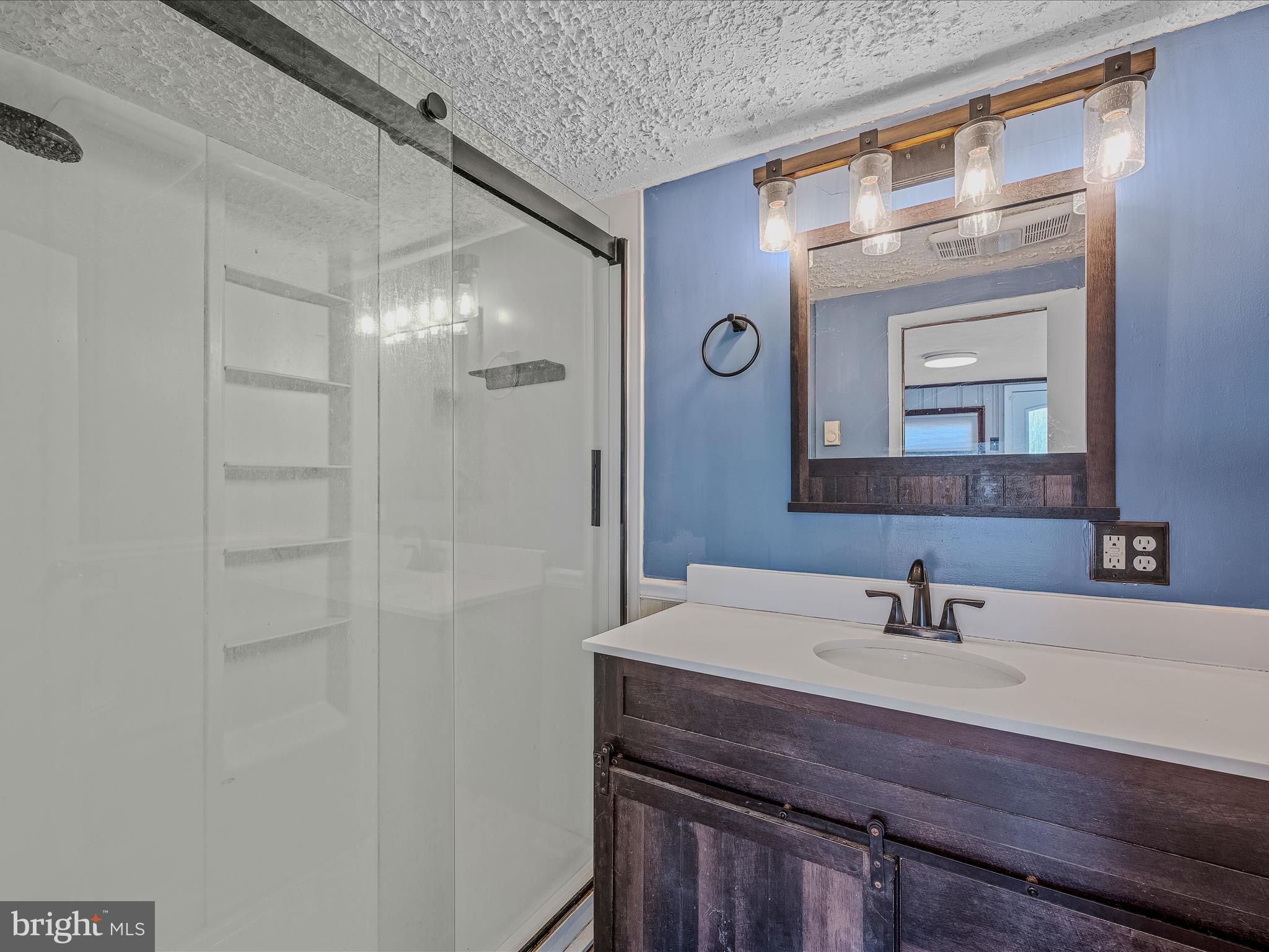 9872 Winchester Avenue Bunker Hill, WV 25413 - Photo 18 of 46 a bathroom with a sink a light fixture and a mirror