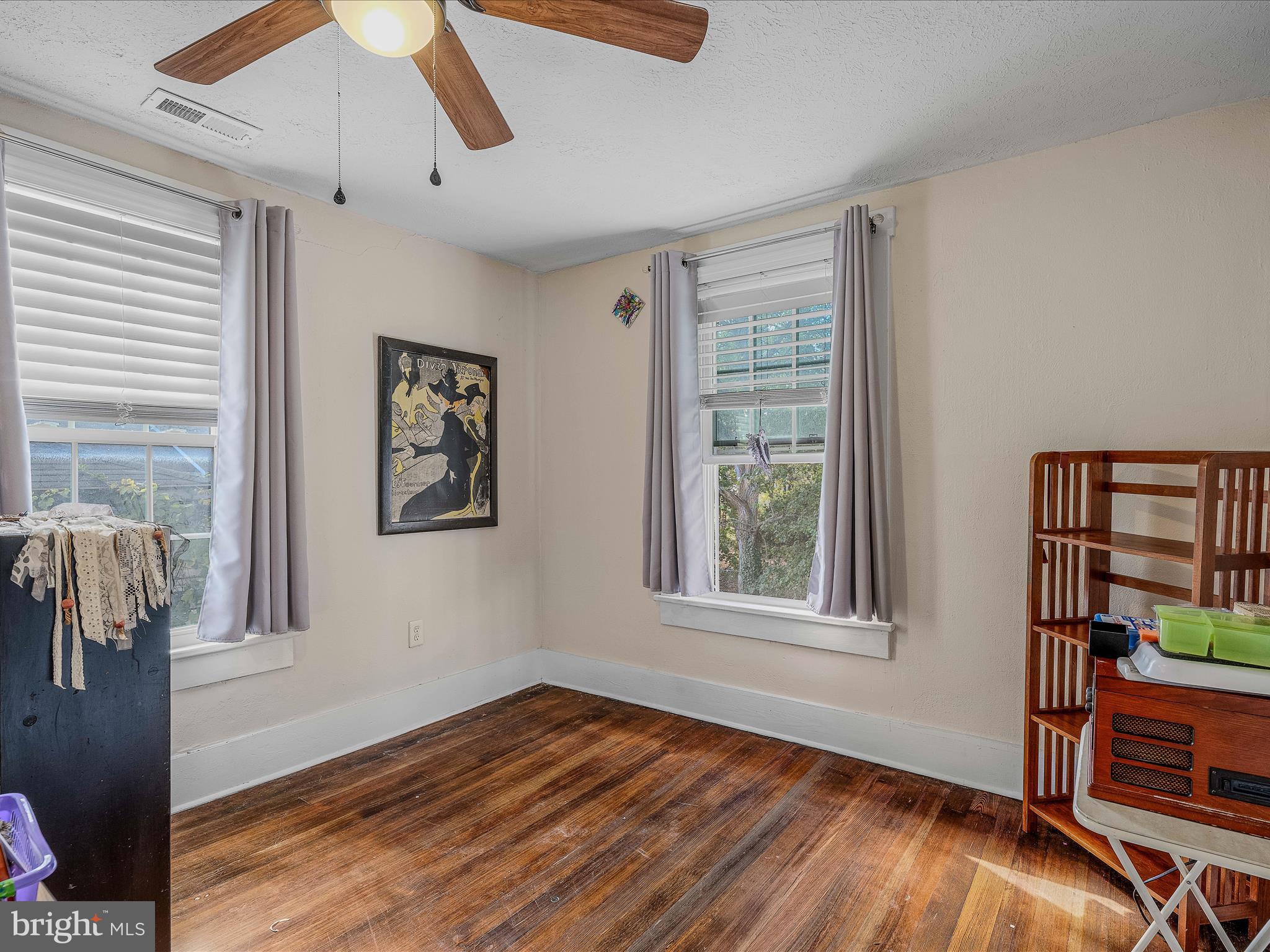 9872 Winchester Avenue Bunker Hill, WV 25413 - Photo 24 of 46 a view of an empty room with wooden floor and a window