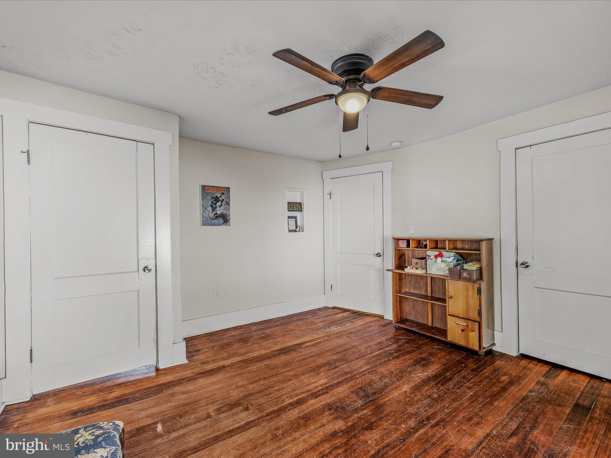9872 Winchester Avenue Bunker Hill, WV 25413 - Photo 28 of 46 a view of a livingroom with wooden floor and a ceiling fan