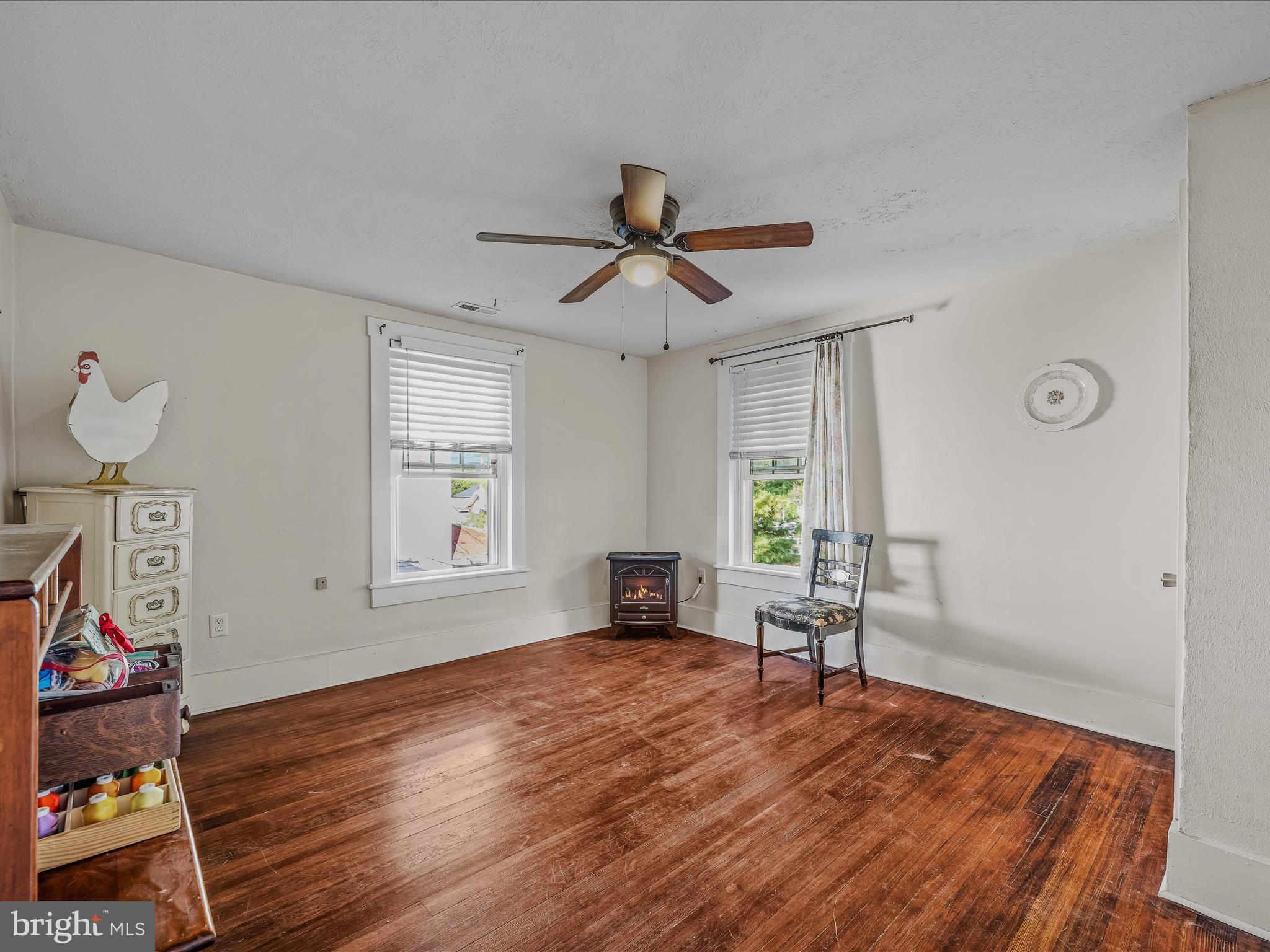 9872 Winchester Avenue Bunker Hill, WV 25413 - Photo 29 of 46 a view of empty room with wooden floor and fan