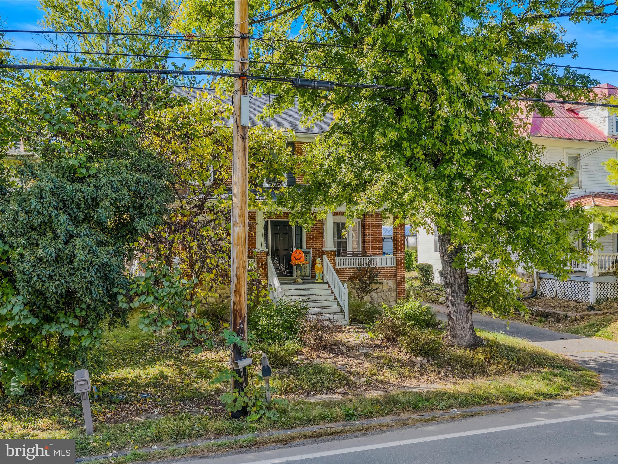 9872 Winchester Avenue Bunker Hill, WV 25413 - Photo 3 of 46 a front view of a house with a yard
