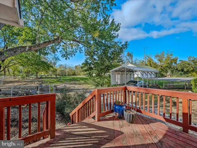a view of a wooden deck with a yard